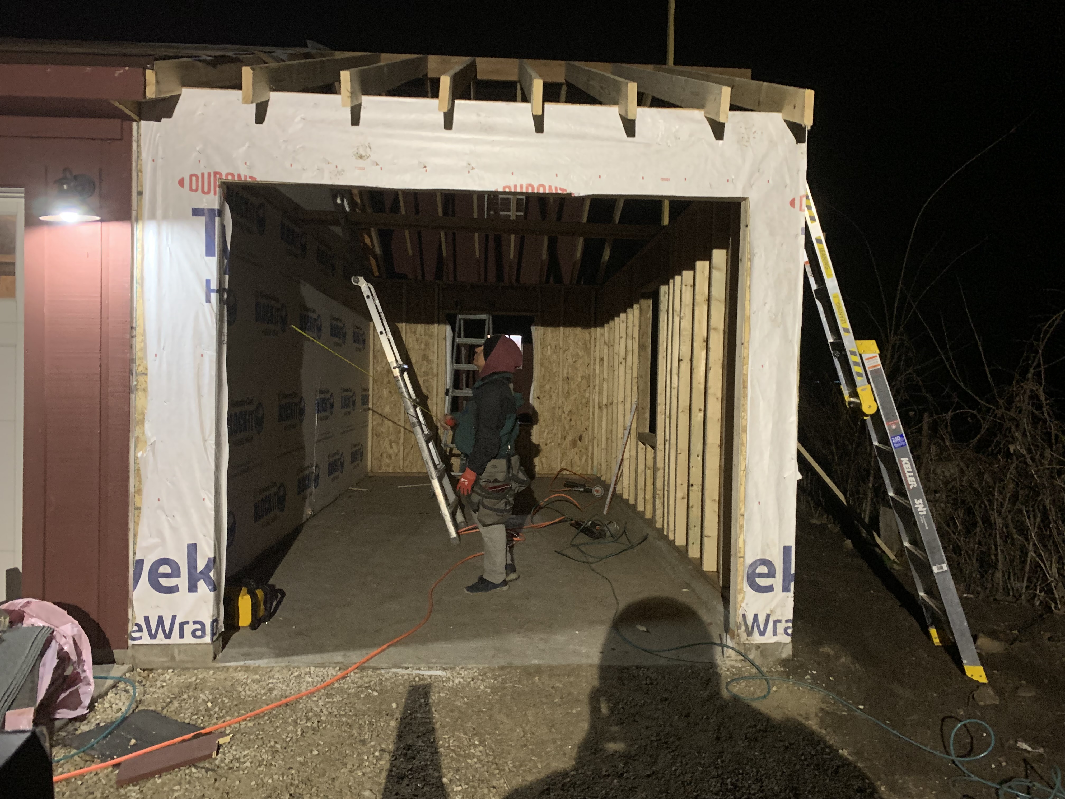 Home addition framing at night Milwaukee