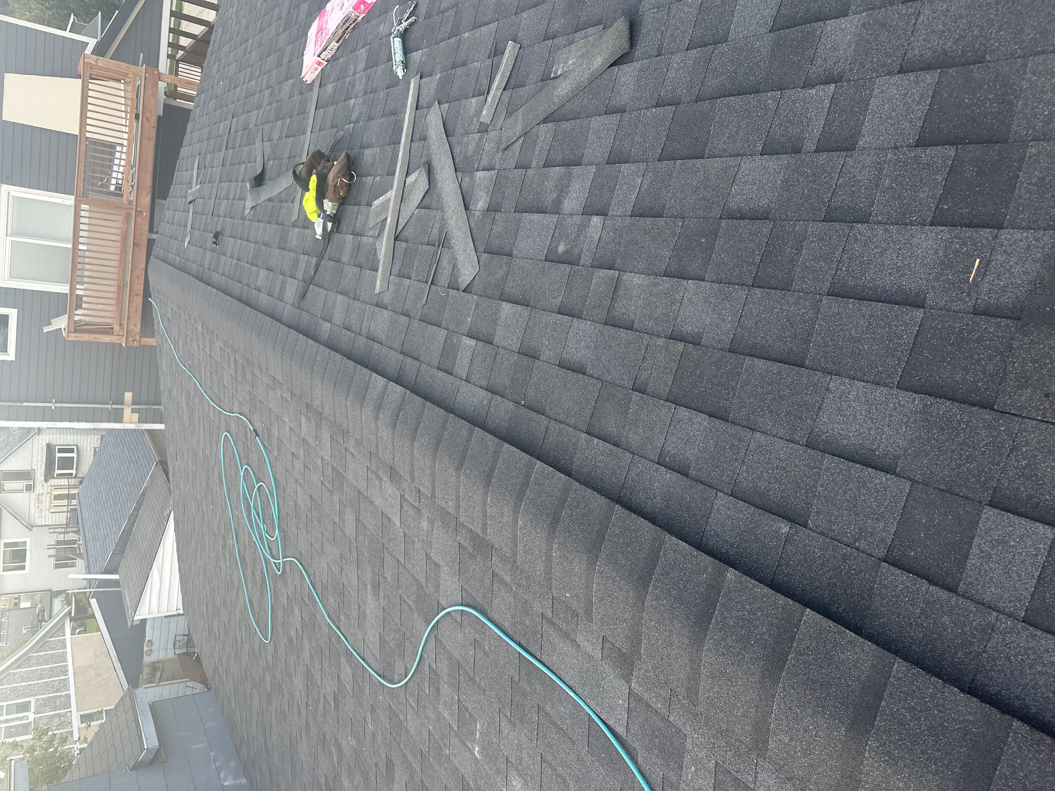 Roofing crew installing shingles Milwaukee